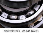 Close-up of a metal ball bearing with polished steel balls. Macro shot of industrial mechanical component. Engineering and machinery concept for design and print.