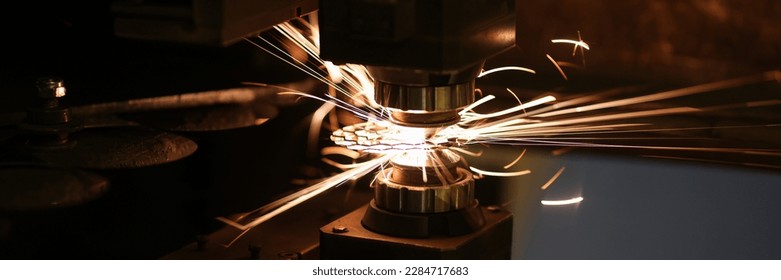 Close-up of metal cutting process and neon sparks flying out. Laser cutting machine and metal sheet. Manufacturing and production concept - Powered by Shutterstock