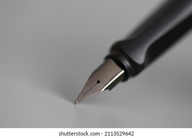 Closeup Of Metal Ink Pen Head On Gray Background