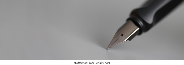 Closeup Of Metal Ink Pen Head On Gray Background