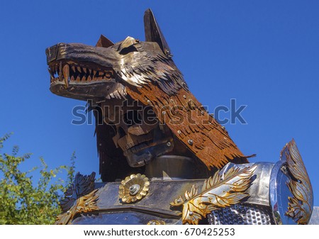 Closeup metal knight-wolf made of details of old cars. Camp of bikers. Russia