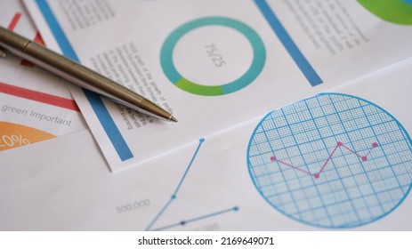 Close-up of metal pen on documents with colourful charts, graphs and diagrams. Planning business documents. Financial strategy calculation. Accountant analysis concept - Shutterstock ID 2169649071