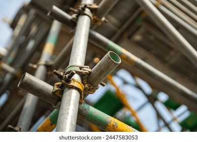 Close-up at metal pipe connection joint of the working platform scaffold at the construction work site. Industrial equipment and object, selective focus. - Powered by Shutterstock