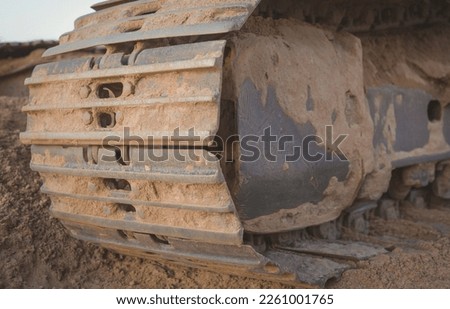 Close-up of metal tracks of a crawler crane with steel wheels. Chassis of tracked vehicles. Track details tracks of bulldozers made of solid steel.