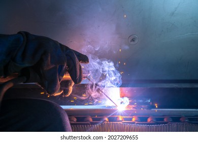 Closeup Of Metal Welder Is Working With Arc Welding Machine To Weld Steel For Assembly Structure Of Machine In Construction Site.