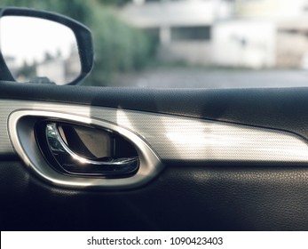 Closeup Metallic Car Door Opener Handle Inside A Modern Car With Sunshine Morning . Selective Focus.