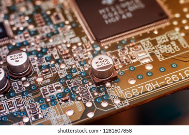 A close-up microchip with many electrical components placed on the Board. The background is blurred.