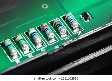 A close-up microchip with many electrical components placed on the Board. The background is blurred.