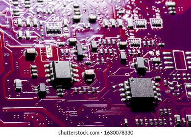 A close-up microchip with many electrical components placed on the Board. The background is blurred.