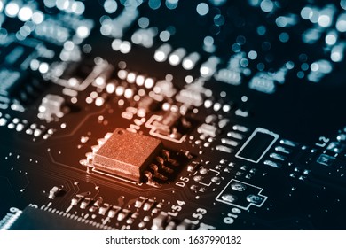 A close-up microchip with many electrical components placed on the Board. The background is blurred.