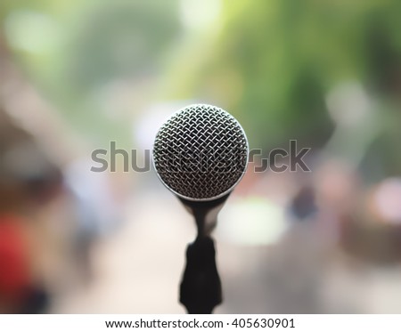 closeup microphone in blurred background with effect film bright light filter, single microphone in the park and blurred background