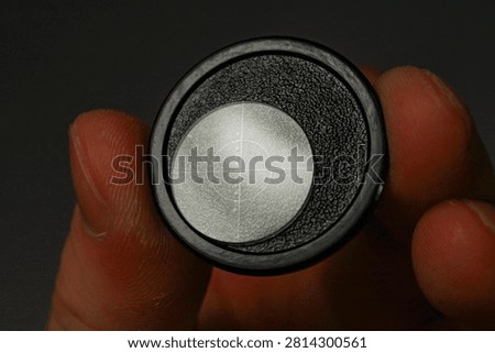 Close-up of a microscope reticle inserted in an optical eyepiece, showing a fine crosshair used for microscopy calibration and metrology.