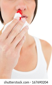 Close-up Mid Section Of A Young Woman With Bleeding Nose Over White Background