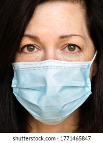 Closeup Of A Middle Aged Woman Wearing A Medical Mask .