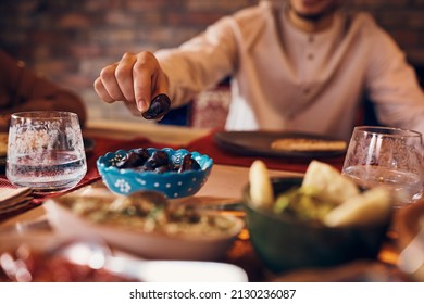 Close-up Of Middle Eastern Man Eating Date During Ramadan Meal At Home. 