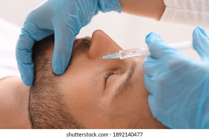 Closeup Of Middle-aged Man Getting Nasolabial Injection At Aesthetic Clinic. Plastic Surgeon Injecting Anti-aging Filler In Handsome Bearded Man Face. Male Cosmetology, Aesthetic Medicine Concept