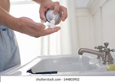 Closeup Midsection Of A Man Preparing To Shave At Bathroom Sink