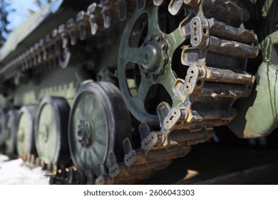 Close-Up of Military Tank Tracks in Snowy Environment