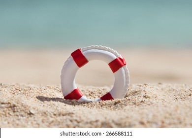 Close-up Of Miniature Lifebuoy On Sandy Beach