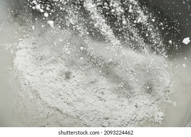 Close-up Of The Mixture In A Bucket Of Powder Putty For Wall Finishing, Putty Or Glaze. Building Materials Concept. Dry Plaster Powder Topcoat. Selective Focus