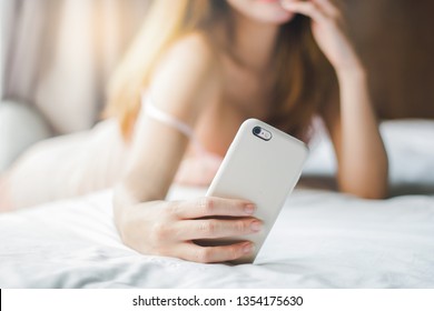 Closeup Mobile In Hand Of Young Asian Woman Selfie On Bed