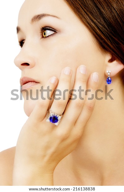 Closeup of a Model Wearing a Tanzanite Designer\
Ring and Earring, Isolated on\
White