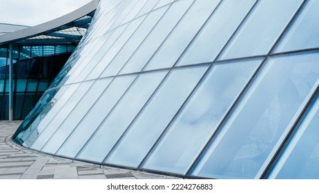 Close-up Modern Architecture, Long Curved Glass Wall Building Exterior.