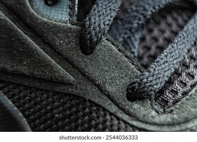 Close-up of a modern athletic shoe highlighting intricate lace details and textured background in daylight - Powered by Shutterstock