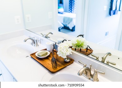 Closeup Of Modern Bathroom His And Her Sinks With White Countertop And Mirror In Staging Model Home, House Or Apartment