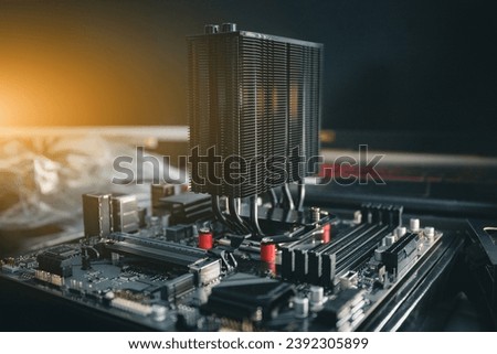 Close-up of a modern computer motherboard with installed cpu and cooler. Electronic computer hardware technology