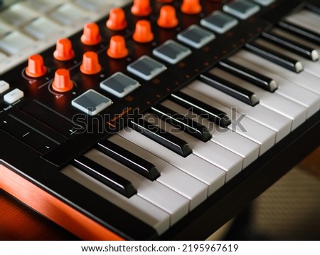 Close-up. Modern electronic musical instrument - midi keyboard. Professional equipment for a recording studio. There are no people in the photo.
