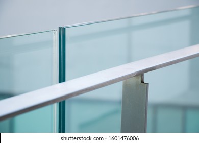 closeup modern flat stainless railing and glass wall on outdoor building.