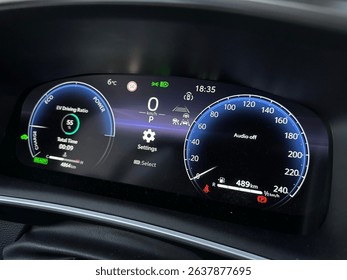 Close-up of a modern hybrid car’s digital dashboard showing driving modes like Eco, Charge, Power, speed, temperature, and system alerts. Clean UI and high-tech concept for future mobility visuals. - Powered by Shutterstock - Get 15% off with code: PIKWIZARD15