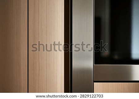Close-up of a modern kitchen featuring light wood cabinetry and sleek stainless steel appliances.