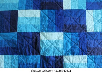 Closeup Of Monochrome Blue Quilt With Rail Fence Blocks And Machine Quilting