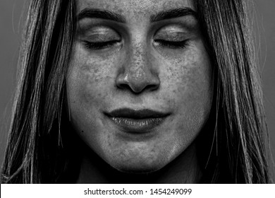 A Closeup And Monochrome View On The Face Of A Twenty Something Caucasian Girl. UV Light Shows Liver Spots And Damaged Skin From Not Using Sun Protection.