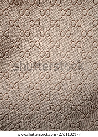 Close-up of a monogrammed leather texture with embossed pattern
