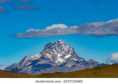 A close-up of Monviso reveals its dramatic, jagged peaks, rising sharply against the sky. The rugged rock face showcases intricate textures and shades, highlighting the mountain's majestic beauty and  - Powered by Shutterstock