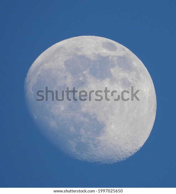 closeup of moon with blue sky as background in\
summer 2021
