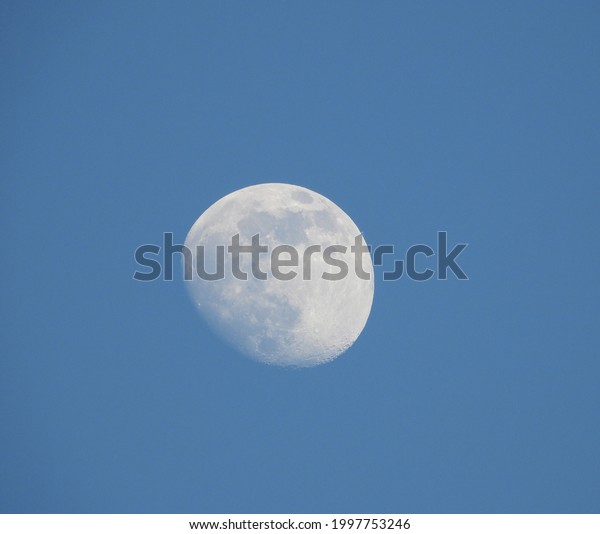 closeup of moon with blue sky as background in\
summer 2021