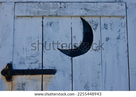 closeup of moon shape on outhouse door ストックフォト © 