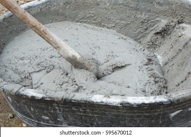 Close-up Of A Mortar Hoe Mixing Fresh Mortar In A Trough