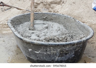 Close-up Of A Mortar Hoe Mixing Fresh Mortar In A Trough