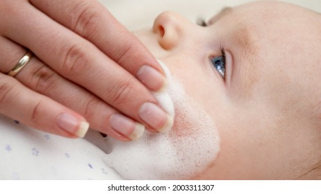 CLoseup Of Mother Applying Medical Ointment For Curing Baby Dermatitis And Acne. Concept Of Newborn Baby Hygiene, Health And Skin Care.