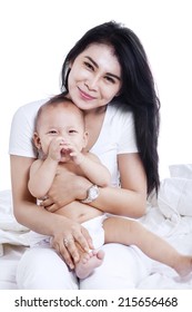 Close-up Of A Mother And Baby Boy Laughing At Home