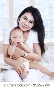 Close-up Of A Mother And Baby Boy Laughing At Home