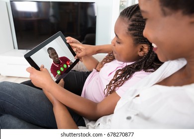 Close-up Of Mother And Daughter Video Conferencing On Tablet At Home - Powered by Shutterstock