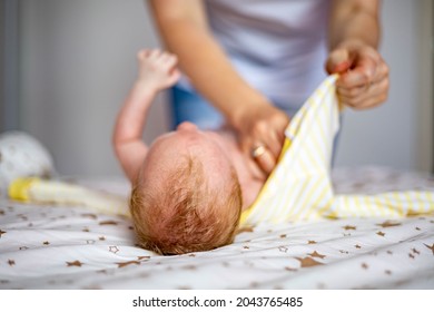 Closeup Mother Hands Swaddle Cute Little Newborn Baby In Fabric Sheet Feeling Love And Tenderness. Happy Mom Taking Care To Toddler Child Spending Time Together Enjoying Motherhood Parenting