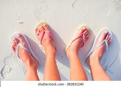 Closeup Mother And Kid Feet On White Sand Beach