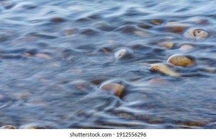 Closeup of Motion-Blurred Water Riffles  Flowing over a Cobble S - Shutterstock ID 1912556296